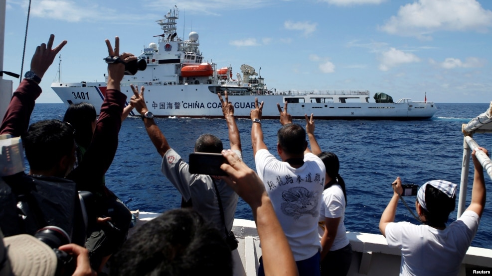 FILE - A Chinese Coast Guard vessel manoeuvres to block a Philippine government supply ship with members of the media aboard at the disputed Second Thomas Shoal, part of the Spratly Islands, in the South China Sea March 29, 2014.
