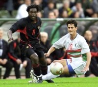 Mbo Mpenza (L) of Belgium is tackled by Rafik Saifi (R) of Algeria during their friendly match at the King Baudouin stadium in Brussels, May 14, 2002. Belgium played Algeria in preparation for the South-Korea/Japan World Cup in June this year. (Reuters | Yves Herman).
