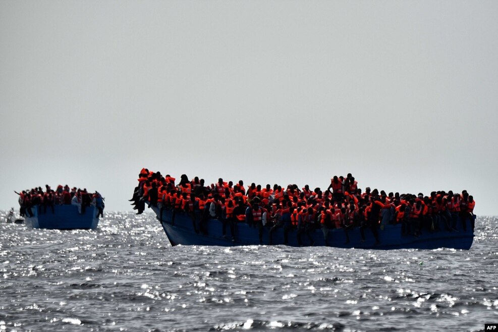 리비아 해안에서 북쪽으로 20해리 떨어진 지중해 해상에서 이민자들이 구조를 기다리고 있다.