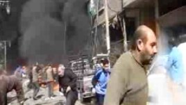 This image taken from video obtained from Ugarit News, which has been authenticated based on its contents and other AP reporting, shows smoke and fire after a fighter jet crashed into a suburb of Damascus, Syria, Feb. 20, 2013.