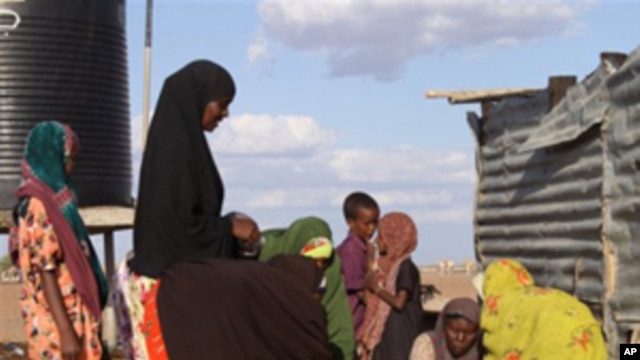 Women fetch water at the site of a borehole in Dertu, Kenya. The microbes that cause diarrhea spread through contaminated food and water, or through poor hygiene and sanitation.