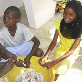 Students tear paper before making paper briquettes, Diourbel, Senegal, December 5, 2011.