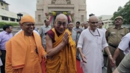 Tibetan spiritual leader the Dalai Lama, center, gestures as he leaves after attending an all faith prayer service for world peace and harmony organized by the Ramakrishna Mission in New Delhi, India, Tuesday, Sept. 11, 2012. (AP Photo/Altaf Qadri)