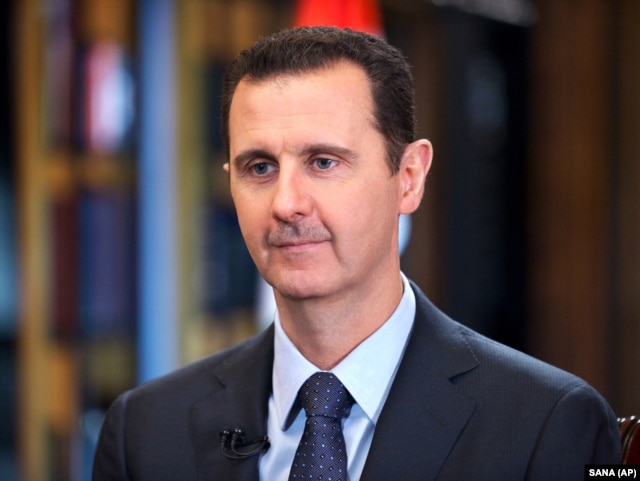 FILE - Syrian President Bashar Assad speaks during an interview with Venezuela's state-run Telesur network, in Damascus, Syria.