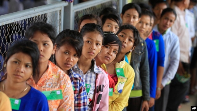 FILE - Cambodian villagers line up at an entrance before the final statements from Nuon Chea and Khieu Samphan at the U.N.-backed war crimes tribunal in Phnom Penh.