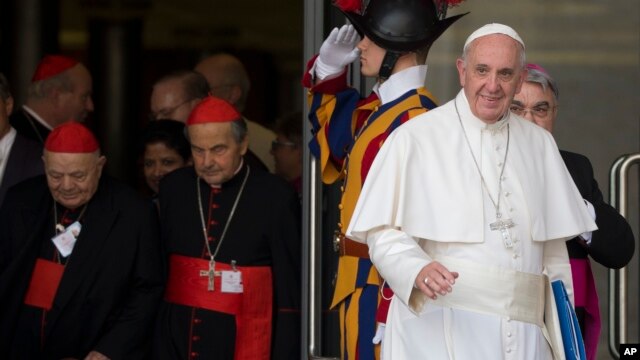 FILE - Pope Francis leaves a morning session of the Synod of bishops, at the Vatican, Oct. 5, 2015.