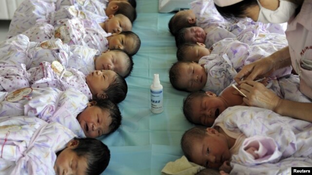 Newly born babies receive vaccines at a hospital in Aksu, Xinjiang Uighur Autonomous Region, August 10, 2012. 