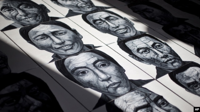 In this photo taken on Dec. 25, 2012, portraits of Tibetans who have self-immolated over the past three years painted by Beijing-based artist Liu Yi are displayed at his studio in Songzhuang art village in Tongzhou, on the outskirts of Beijing.