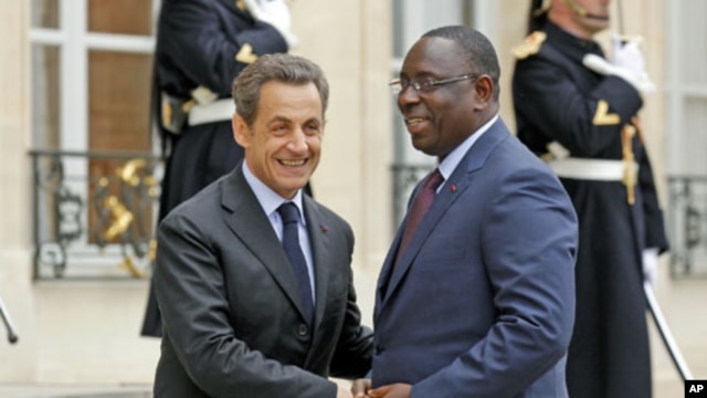 France's President Nicolas Sarkozy (L) greets Senegal's newly-elected President Macky Sall at the Elysee Palace in Paris, April 18, 2012.