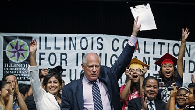 Illinois Governor Pat Quinn celebrates with students and supporters after signing the Illinois Dream Act into law at a Latino neighborhood high school in Chicago, Aug 1, 2011