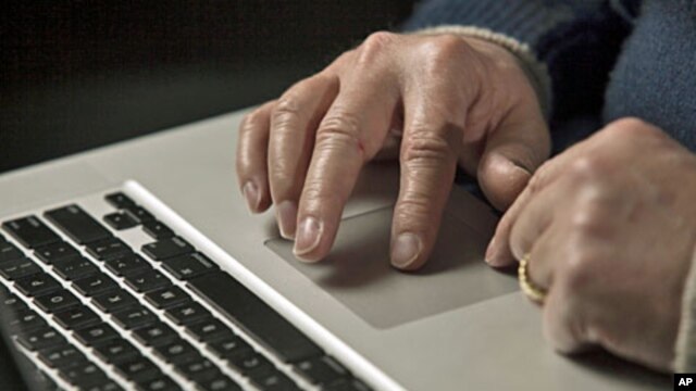 A cyber warfare expert works on his laptop computer  in Charlotte, North Carolina, December 1, 2011.