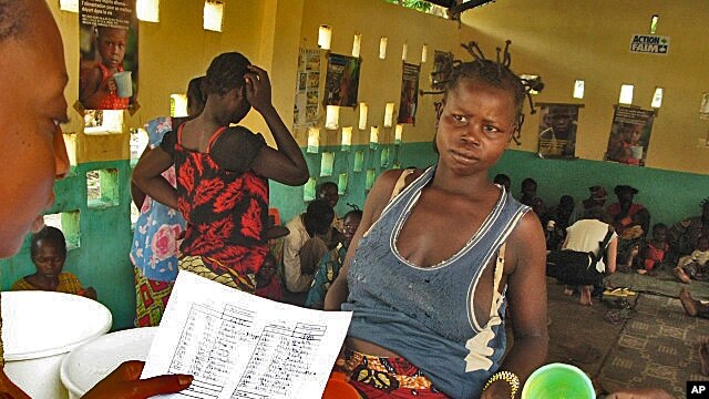 A mother waits for milk at a feeding center in the conflict-torn Central African Republic