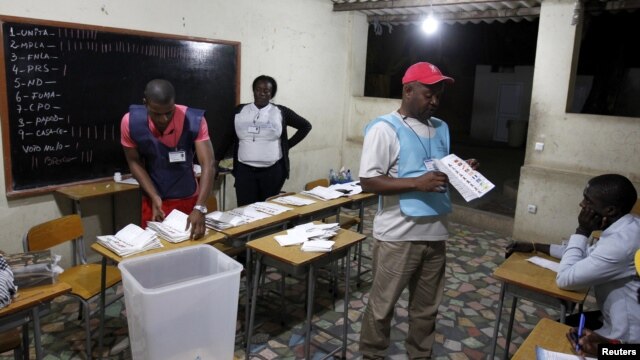 Election officials count ballot papers after the closing of the national election in the capital Luanda, Angola, August 31, 2012.