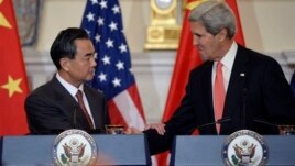 John Kerry and Wang Yi shake hands after making statements before their meeting. Sept. 19, 2013. 