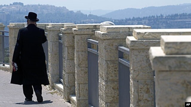 An ultra-Orthodox Jewish man walks in Ramat Shlomo, a religious Jewish settlement in an area of the West Bank annexed to Jerusalem by Israel. Israel's interior minister has given final approval for a plan to build 1,600 settler homes in the East Jerusalem