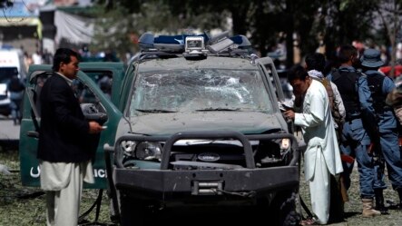 Afghan security forces personnel investigate the site of an explosion in Kabul, June 18, 2013.  