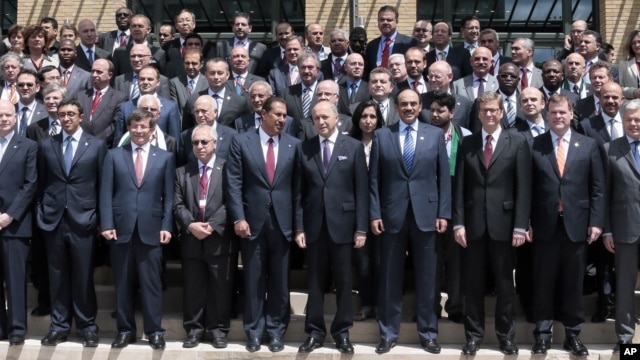 French Foreign Minister Laurent Fabius, center, stands with representatives of other Friends of the Syrian People of Syria at their Paris meeting, Friday, July 6. 