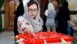 An Iranian woman casts her ballot for the parliamentary runoff elections in a polling station at the city of Qods about 12 miles (20 kilometers) west of Tehran, April 29, 2016.