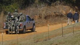 Law enforcement officials including the FBI at the scene of a shooting and hostage taking near Midland City, Alabama February 1, 2013. 