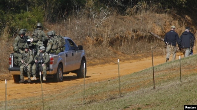 Law enforcement officials including the FBI at the scene of a shooting and hostage taking near Midland City, Alabama February 1, 2013. 