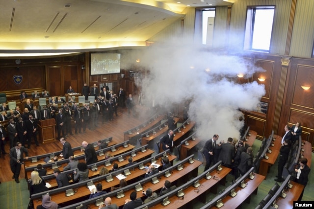 Opposition politicians release tear gas in parliament to obstruct a session in Pristina, Kosovo, Feb. 19, 2016.