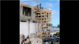 Construction workers restore a Bakara Market business destroyed in the August, 2011 fighting. (Pete Heinlein, VOA)