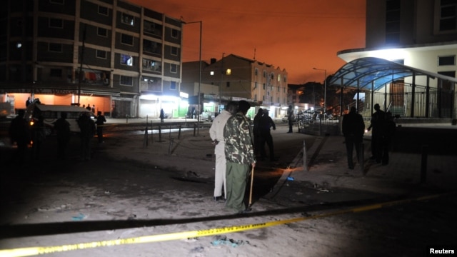 Policemen inspect the secured section at the scene of the blast in Eastleigh suburb of Kenya's capital Nairobi, December 7, 2012.