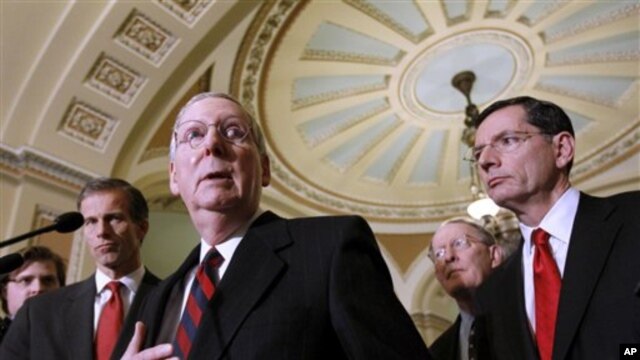 Senate Minority Leader Mitch McConnell of Ky., second from left, gestures during a news conference on Capitol Hill in Washington, Tuesday, Dec. 7, 2010. From left are, Sen. John Thune, R-S.D., McConnell, Sen. Lamar Alexander, R-Tenn., and Sen. John Barras