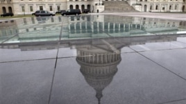 The dome of the Capitol is reflected in a skylight of the Capitol Visitor's Center in Washington, January 1, 2013.