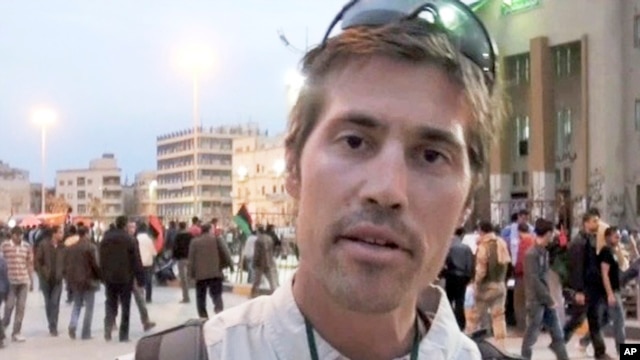FILE - This undated file still image from video released April 7, 2011, by GlobalPost, shows James Foley of Rochester, N.H., a freelance contributor for GlobalPost, in Benghazi, Libya.