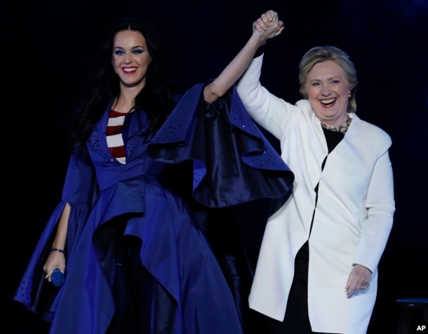 Katy Perry holds hands with Democratic presidential nominee Hillary Clinton during a concert at the Mann Center for the Performing Arts, Nov. 5, 2016, in Philadelphia.