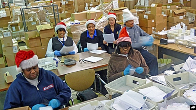 Some of the 22 postal  "elves" who volunteer to organize letters to Santa and arrange for the public or charities to "adopt" them.