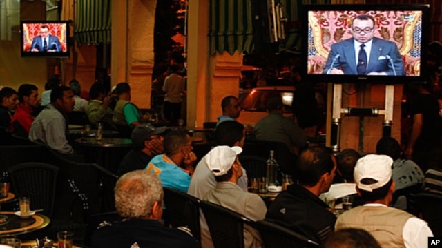 Moroccan customers at a cafe in Casablanca watch a live broadcast from Rabat of a speech by Morocco's King Mohammed VI, June 17, 2011
