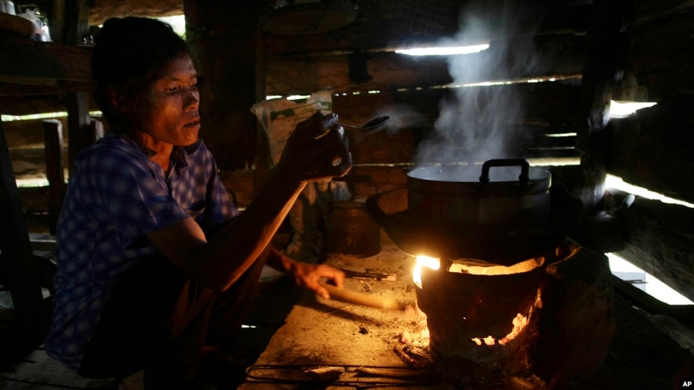 A local villager cooks dinner in Ta Thorng village, in Koh Kong province, some 140 kilometers (87 miles) west of Phnom Penh, Cambodia, Thursday, Nov. 22, 2012. Like many poor people in rural Cambodia, she has no electricity and uses a small wood burning stove to cook rice, the staple food nationwide. (AP Photo/Heng Sinith)