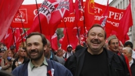 Opposition activists Gennady Gudkov, right, and Ilya Ponomarev, a lawmaker, left, march with opposition supporters heading to a protest rally in Moscow, September 15, 2012.