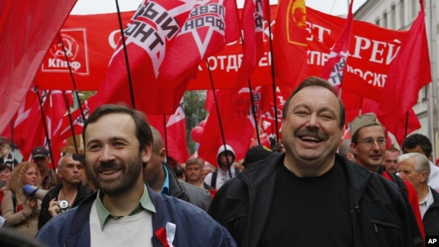 Opposition activists Gennady Gudkov, right, and Ilya Ponomarev, a lawmaker, left, march with opposition supporters heading to a protest rally in Moscow, September 15, 2012.