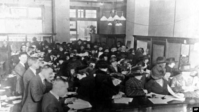 Americans fill out forms at an Internal Revenue Service office in 1920, seven years after the personal income tax was introduced.