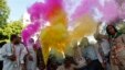 Supporters of India's ruling Congress party use color crackers during election celebrations outside party headquarters in Ahmedabad on May 8, 2013.