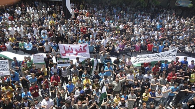 Demonstrators protest against Syria's President Bashar Al-Assad in Kafranbel, near Idlib, April 27, 2012.  