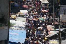 People crowd a street in a market in Lagos, which is expected to overtake Cairo soon as Africa's largest city.