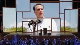 Delegates watch a video presentation during an abbreviated session of the Republican National Convention in Tampa, Fla., Aug. 27, 2012. 