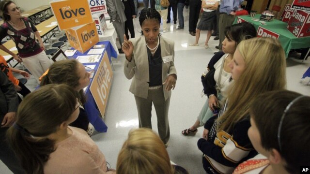 This Oct. 9, 2012, photo shows Utah Republican candidate Mia Love talking with students during the Granite PTA meet the candidates at Skyline High School in Salt Lake City.