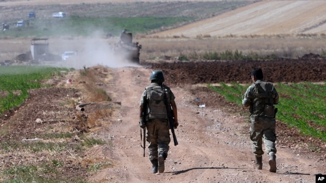 FILE - Turkish soldiers patrol near the border with Syria, ouside the village of Elbeyli, east of the town of Kilis, southeastern Turkey, July 24, 2015.