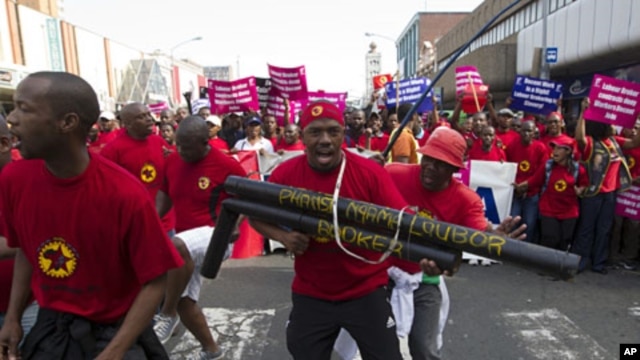 Striking workers belonging to unions under the Congress of South African Trade Unions march through Durban, July 12, 2011