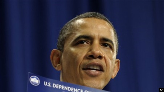 President Barack Obama holds up a chart as he speaks about his energy policies March 1, 2012 in Nashua, New Hampshire.