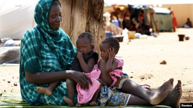Malian family displaced by war gather at a makeshift camp in Sevare, about 400 miles northeast of Bamako, July 11, 2012.