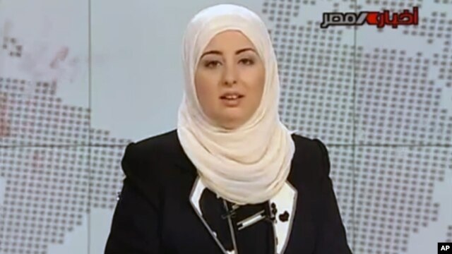 Egypt State TV, Fatma Nabil reads out the headlines wearing a headscarf on the noon news bulletin on state television in Cairo, Egypt, Sept. 3, 2012.