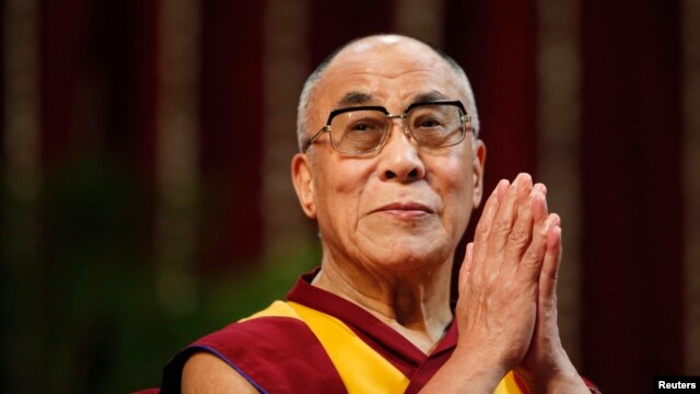 FILE - The Dalai Lama gestures before speaking to students during a talk at Mumbai University.