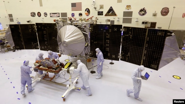 Technicians work on NASA's next Mars-bound spacecraft, the Mars Atmosphere and Volatile Evolution (MAVEN) spacecraft, as it is displayed for the media at the Kennedy Space Center in Cape Canaveral, Florida September 27, 2013. MAVEN is the first spacecraft