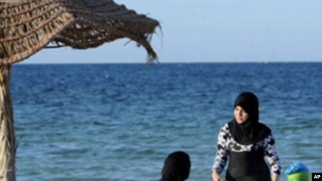 Veiled women sitting on a deck chairs on the beach in Sangho hotel in Zarzia, south Tunisia on July 30, 2010.